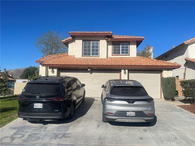 mediterranean / spanish house with a garage