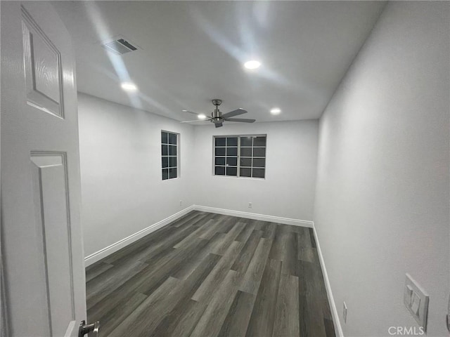 empty room featuring ceiling fan and dark hardwood / wood-style flooring