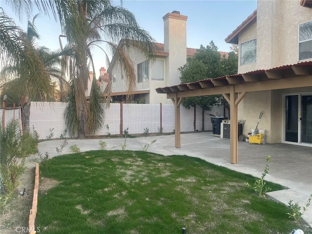 view of yard with a patio and central AC unit