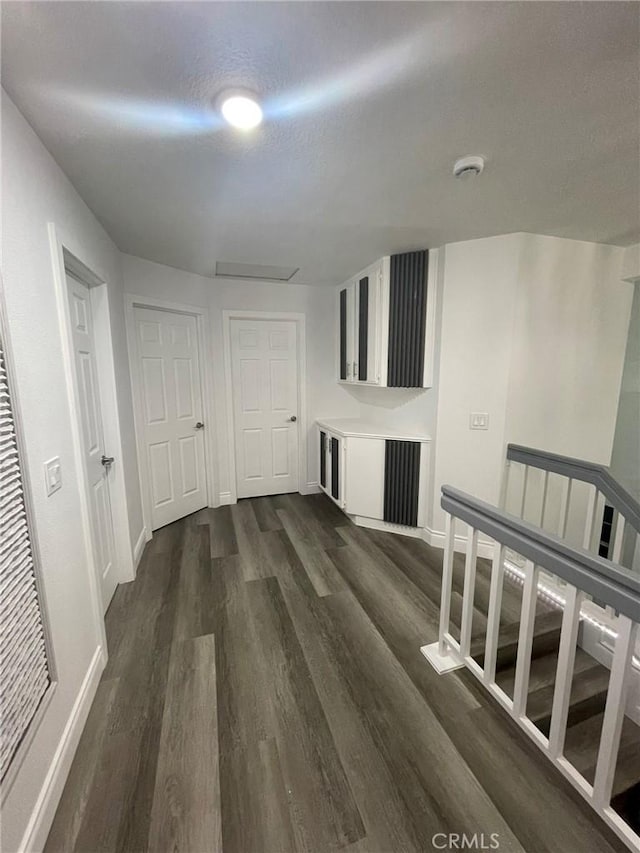 hallway with dark hardwood / wood-style floors