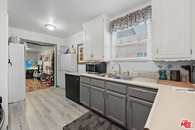 kitchen with white cabinetry, sink, white fridge, light hardwood / wood-style floors, and gray cabinets