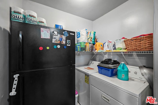 clothes washing area featuring washer and clothes dryer