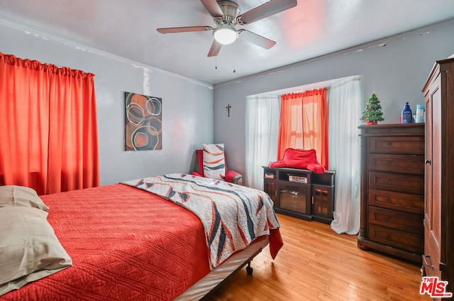 bedroom with ceiling fan and hardwood / wood-style floors