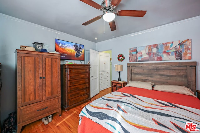 bedroom with ceiling fan, crown molding, and light hardwood / wood-style floors