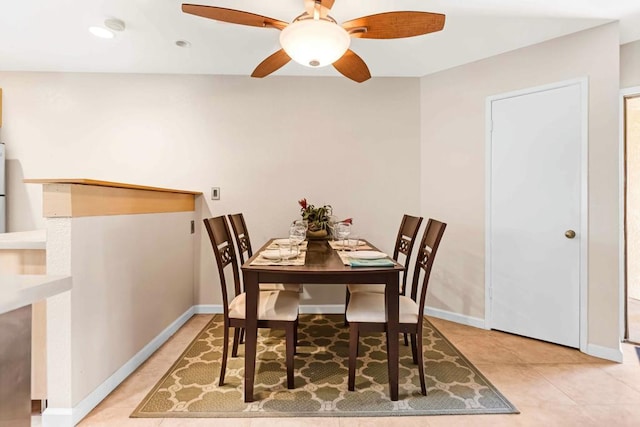 dining room featuring ceiling fan and light tile patterned flooring