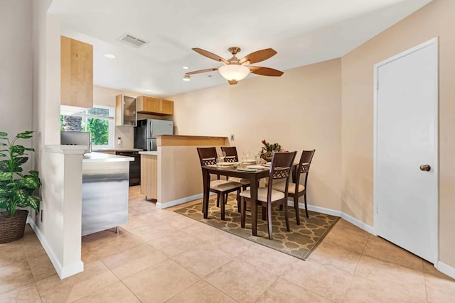 dining area with ceiling fan and light tile patterned floors