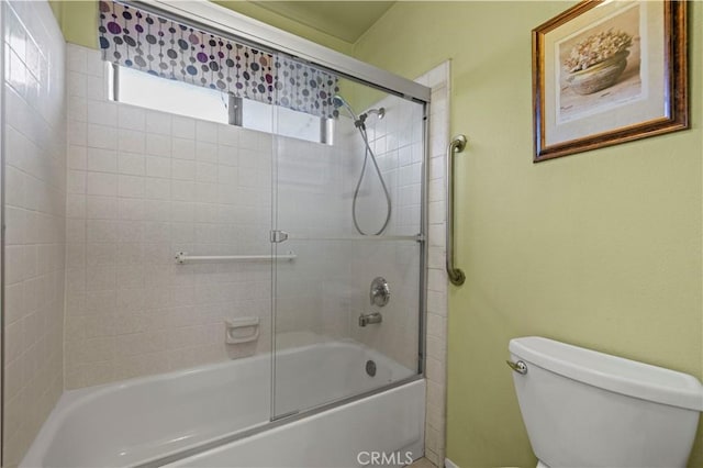 bathroom with toilet and enclosed tub / shower combo