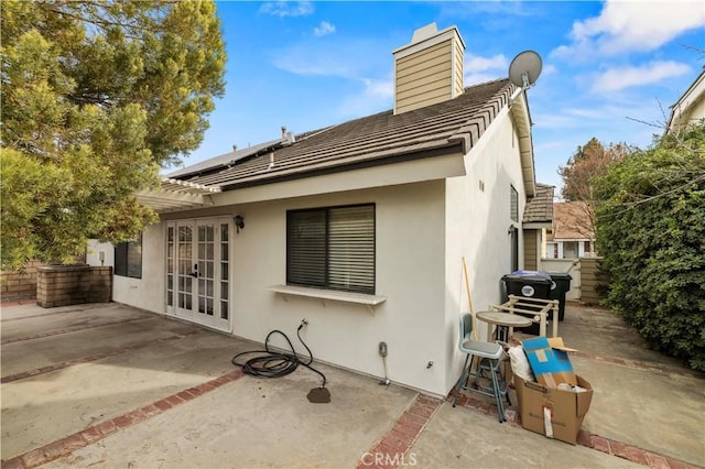 back of property featuring a patio and french doors