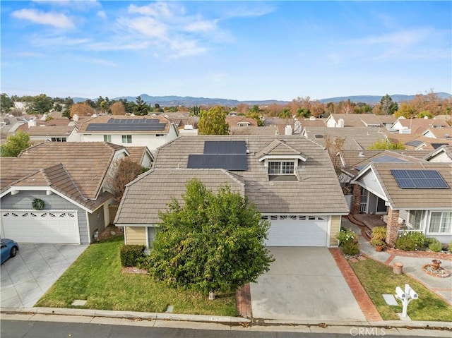 view of front of property with solar panels and a mountain view