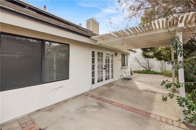 view of patio / terrace with a pergola and french doors