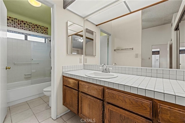 full bathroom with toilet, vanity, tile patterned floors, and tub / shower combination