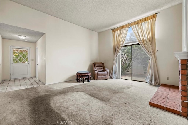 unfurnished room featuring a textured ceiling, light carpet, and a wealth of natural light