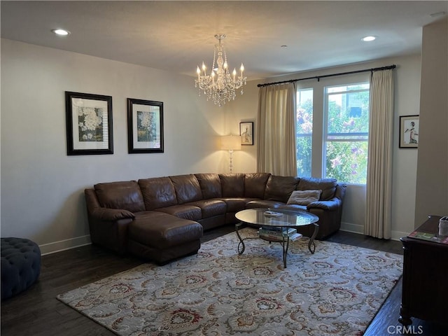living room featuring a chandelier and dark hardwood / wood-style flooring