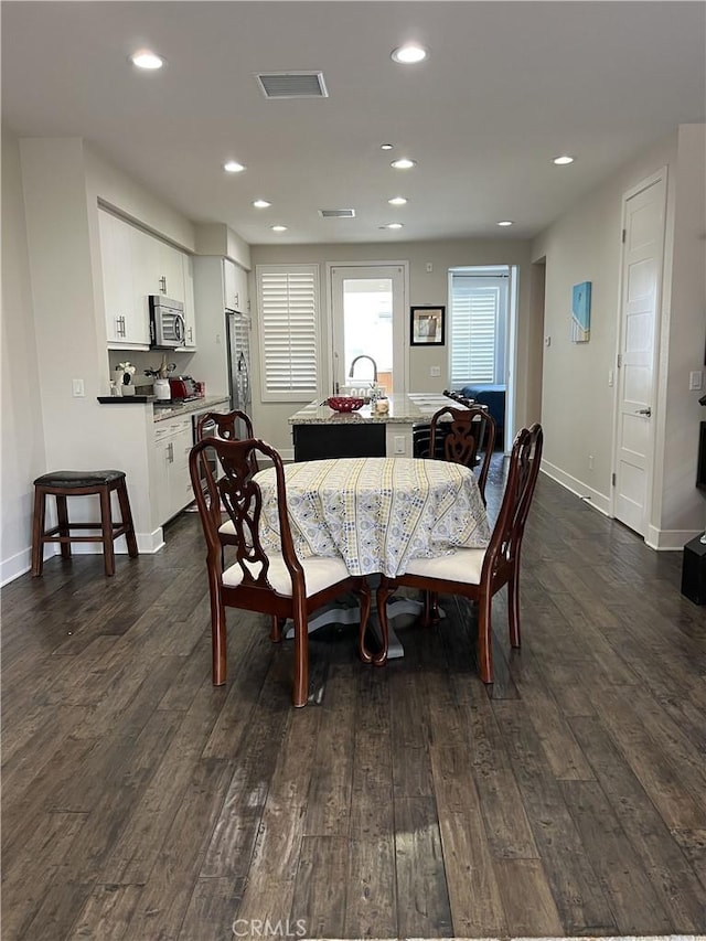 dining space featuring sink and dark hardwood / wood-style floors