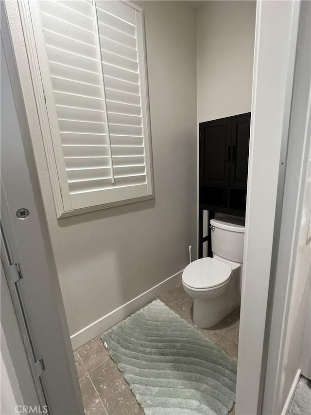 bathroom featuring tile patterned floors and toilet