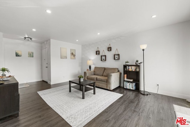 living room with dark hardwood / wood-style flooring