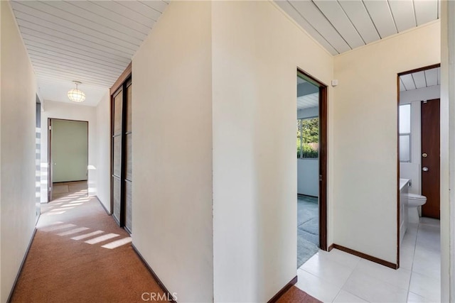 hall featuring light colored carpet