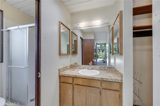 bathroom featuring an enclosed shower and vanity