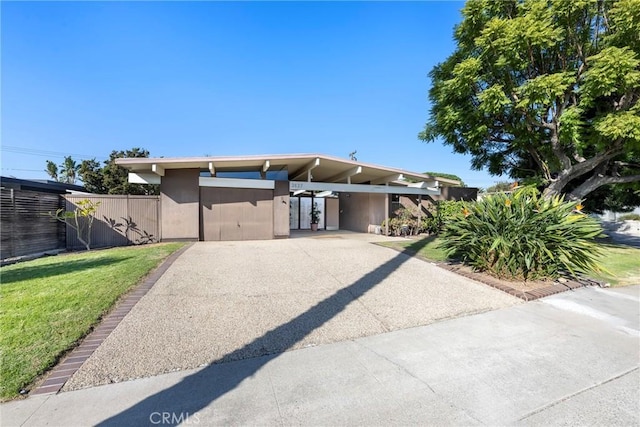 view of front of house with a front lawn and a carport