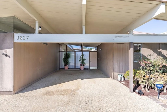 view of exterior entry featuring a carport