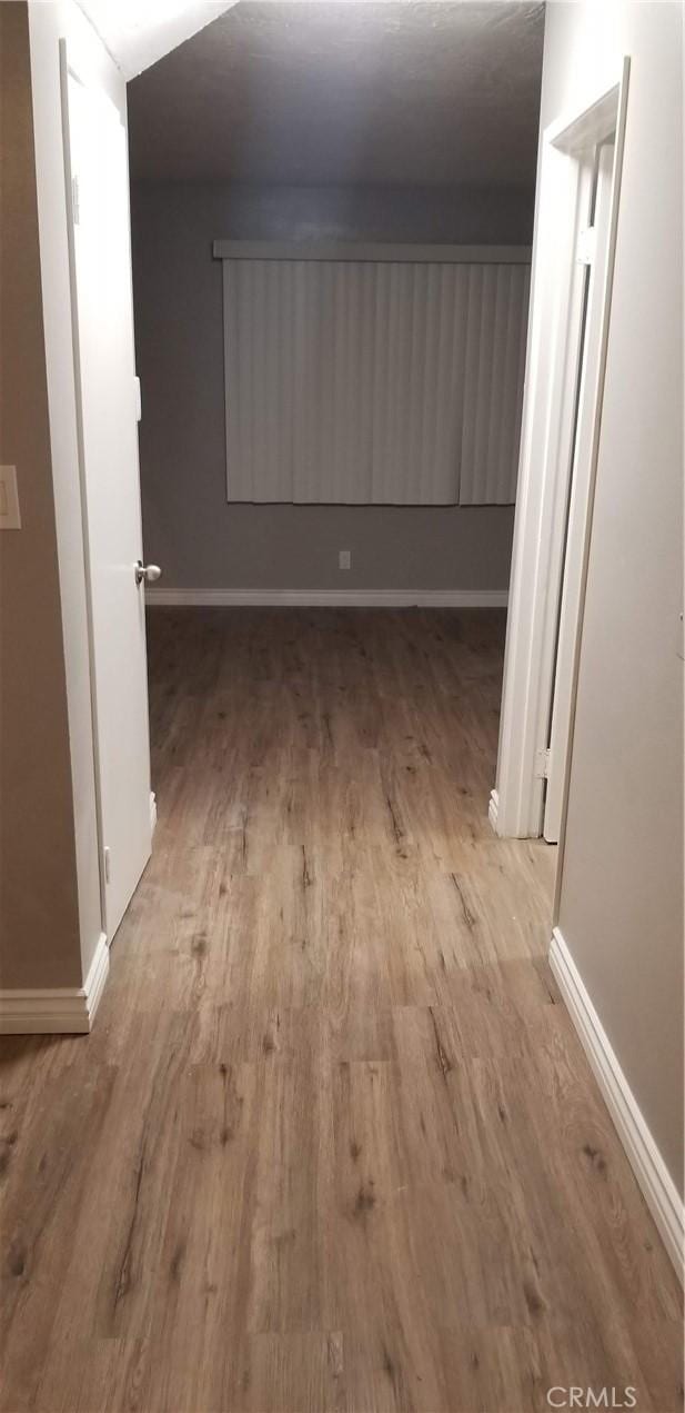 corridor with light wood-type flooring