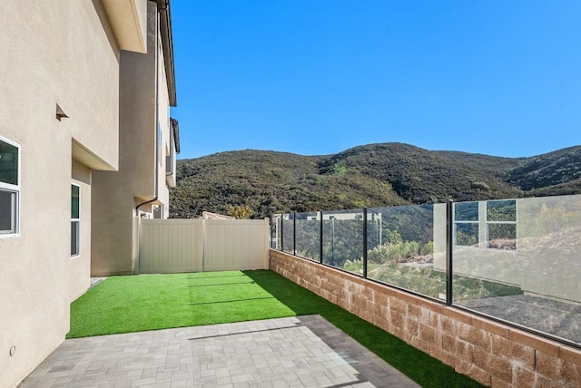 view of yard with a mountain view and a patio area