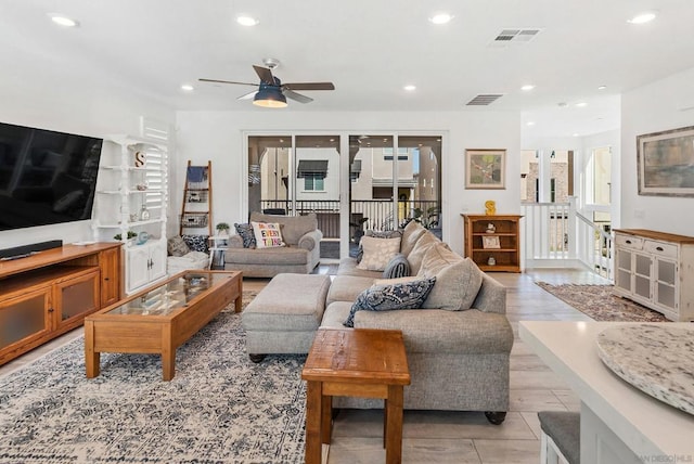 living room featuring ceiling fan and light hardwood / wood-style flooring