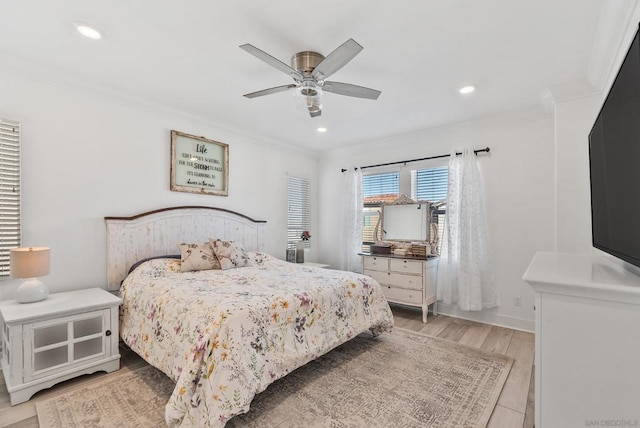 bedroom with light wood-type flooring, ceiling fan, and crown molding