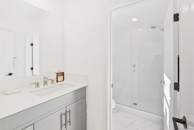 bathroom featuring vanity, toilet, and an enclosed shower