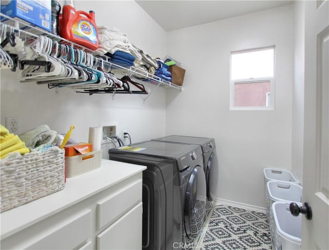 washroom with washing machine and dryer and light tile patterned floors