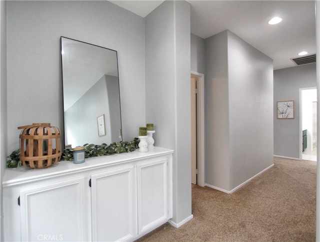 hallway featuring light carpet