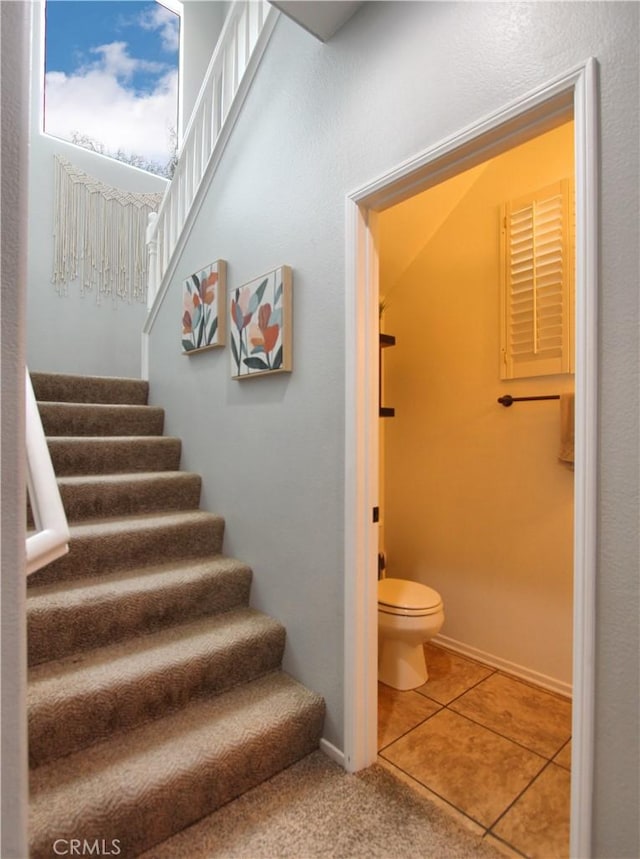 stairway with tile patterned floors