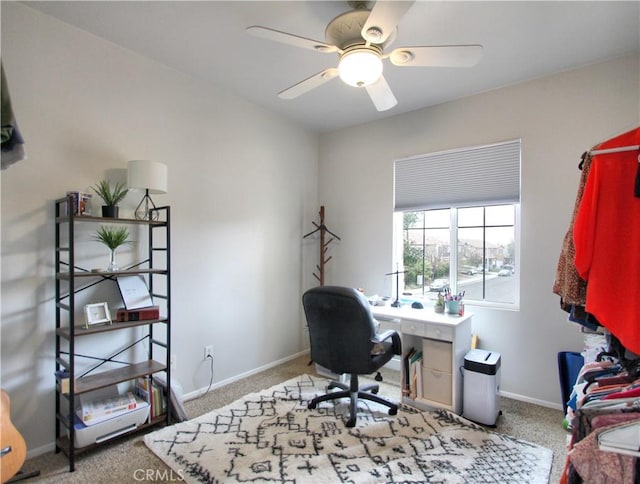 carpeted office featuring ceiling fan