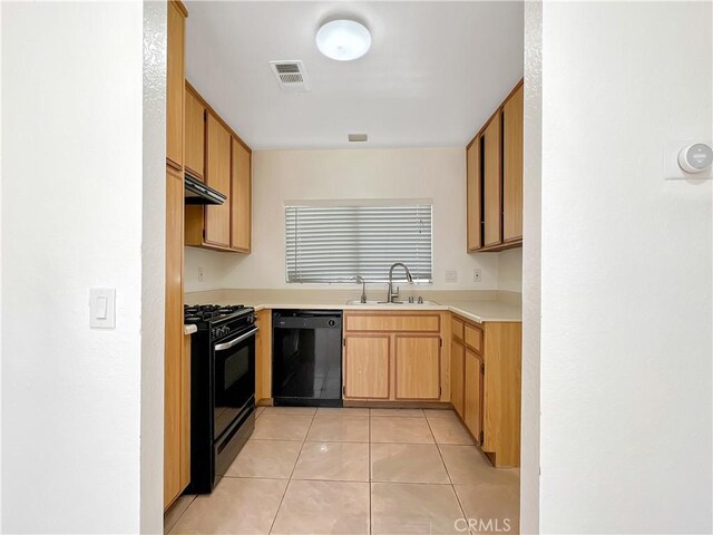 kitchen featuring black appliances, light tile patterned flooring, and sink