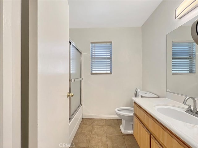 full bathroom with tile patterned floors, vanity, toilet, and enclosed tub / shower combo