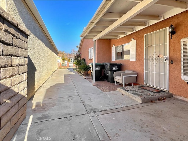 view of exterior entry with a patio area