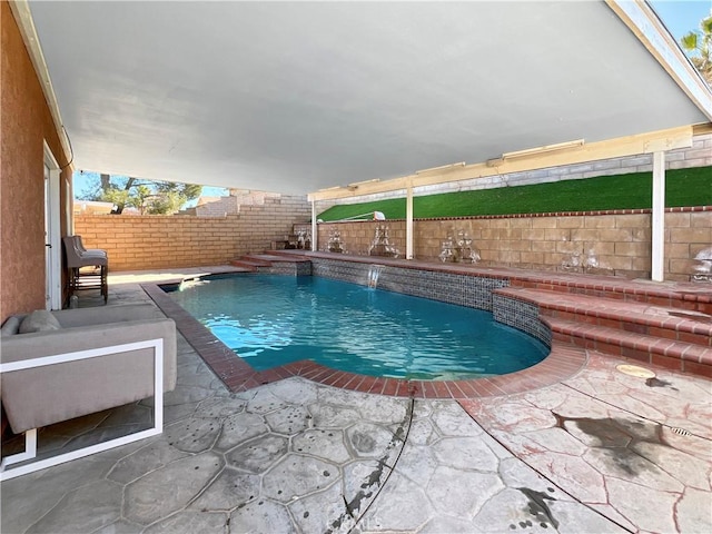 view of pool with pool water feature and a patio