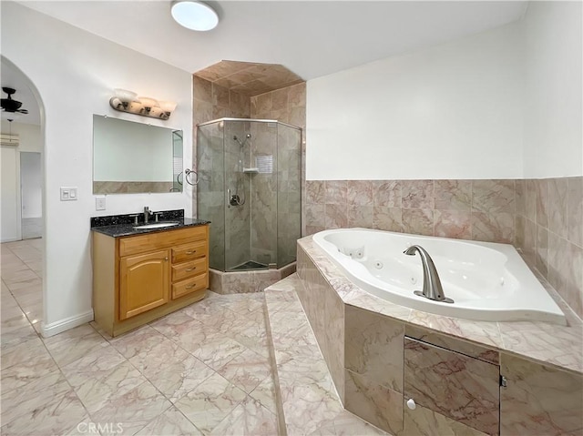 bathroom featuring vanity, separate shower and tub, and ceiling fan