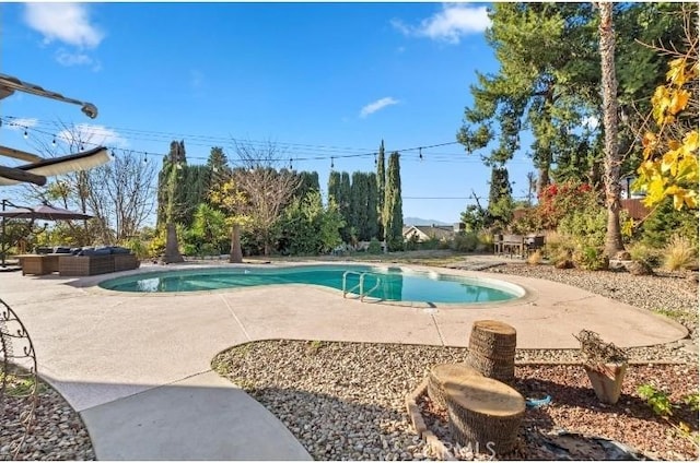 view of swimming pool featuring an outdoor living space and a patio