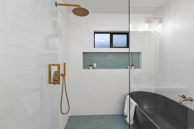 bathroom with tile walls and tiled shower