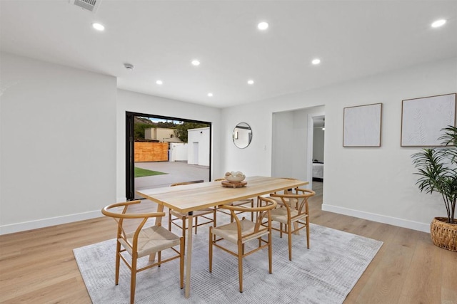 dining space with light hardwood / wood-style flooring