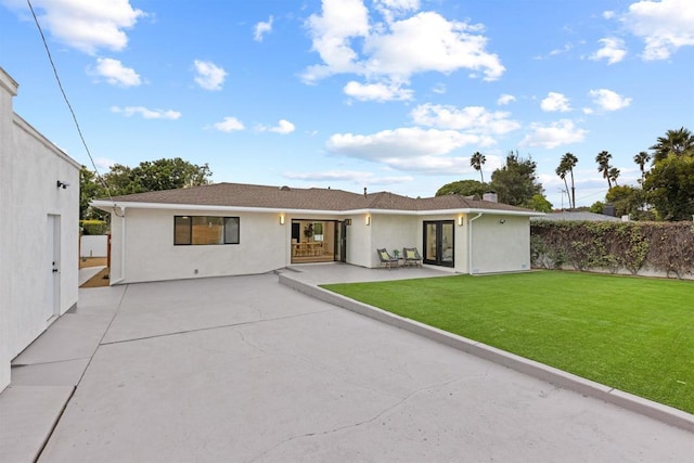 back of house featuring a patio area and a yard