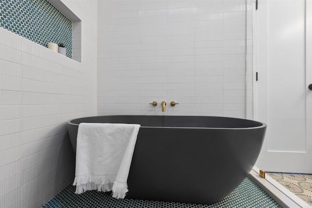 bathroom with tile walls and tile patterned floors