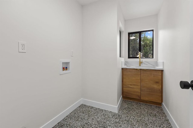 laundry room with cabinets, washer hookup, and sink