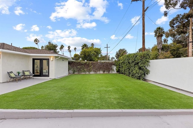 view of yard featuring french doors and a patio area