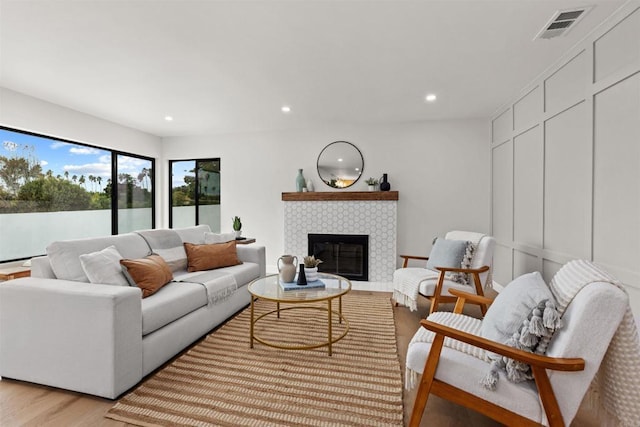 living room featuring light hardwood / wood-style flooring and a fireplace