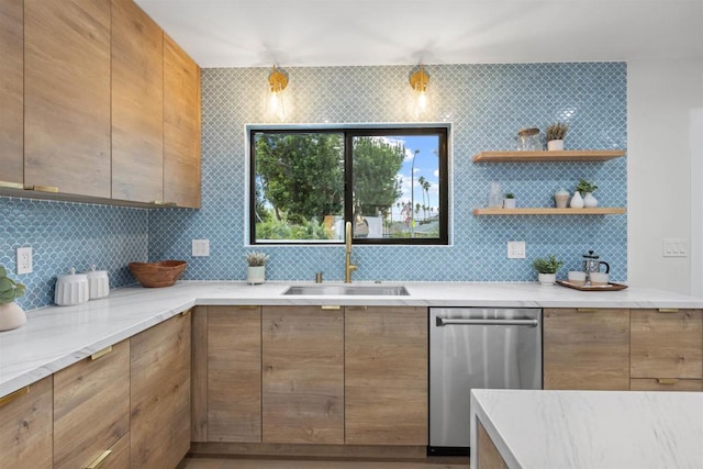 kitchen featuring decorative light fixtures, tasteful backsplash, sink, light stone counters, and stainless steel dishwasher