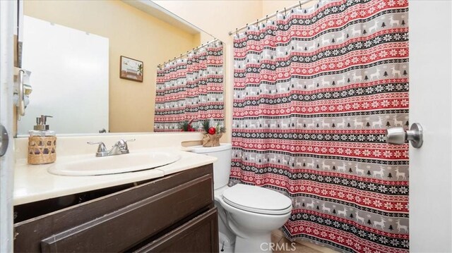 bathroom with vanity, tile patterned floors, and toilet