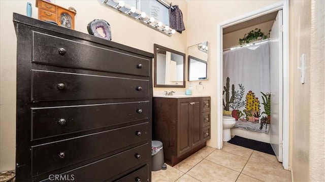 bathroom with vanity, tile patterned flooring, and toilet