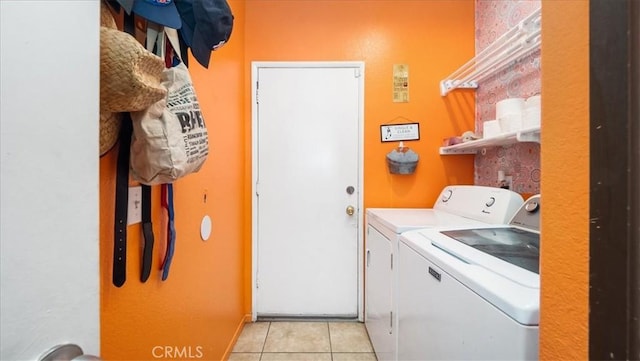 laundry room featuring light tile patterned flooring and washing machine and clothes dryer